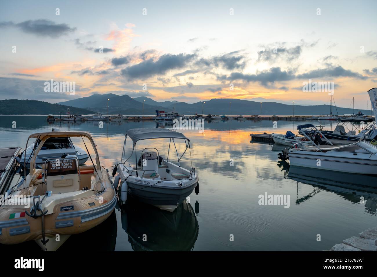 Lefkada island. Greece- 10.16.2023. Beautiful sunrise sky clouds reflections on the still water of Ligia harbour. Stock Photo