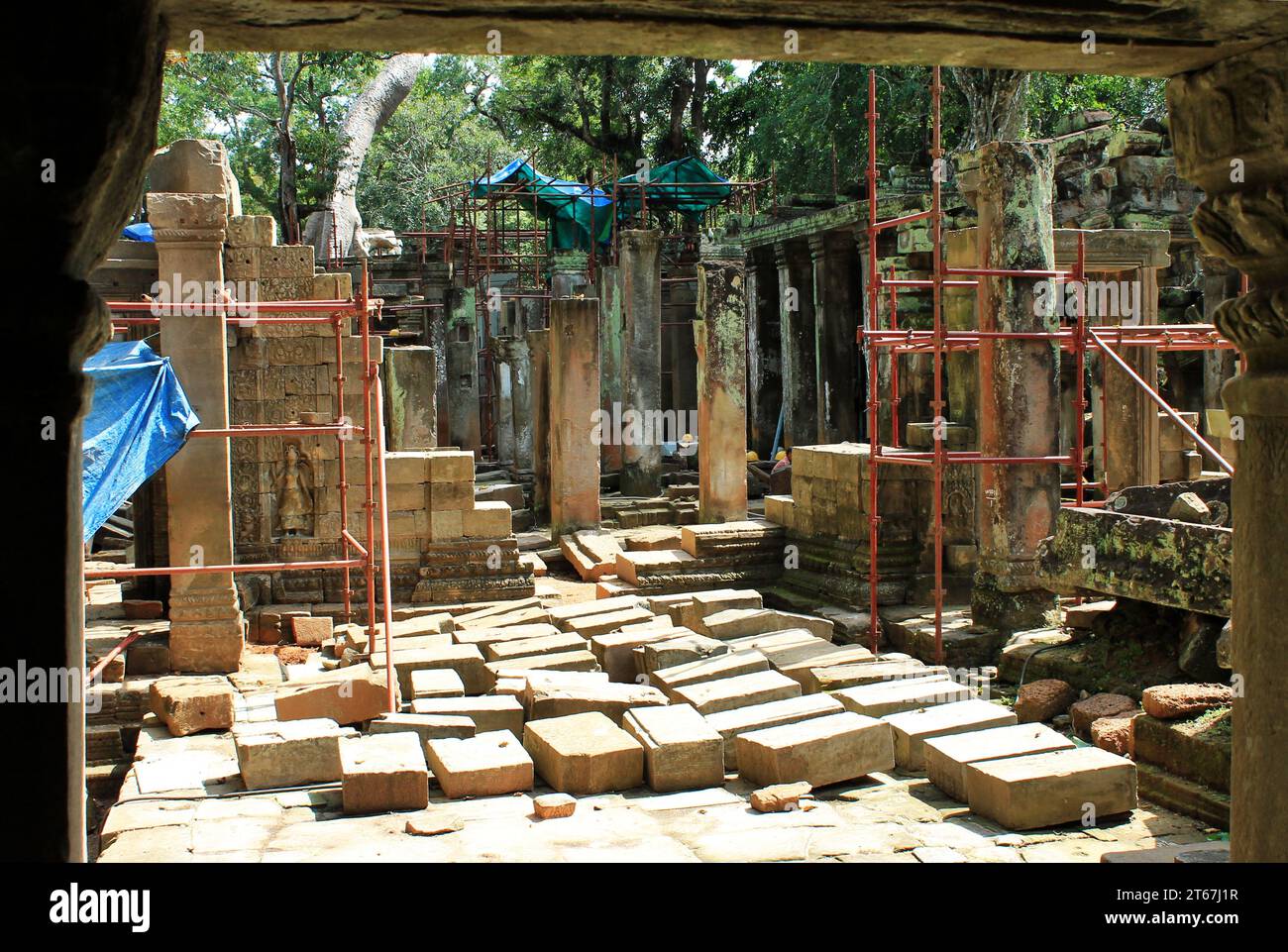 Temple restoration underway among the ruins at Angkor Archaeological Park. Ancient ruins are slowly being rebuilt at the Cambodian UNESCO site Stock Photo