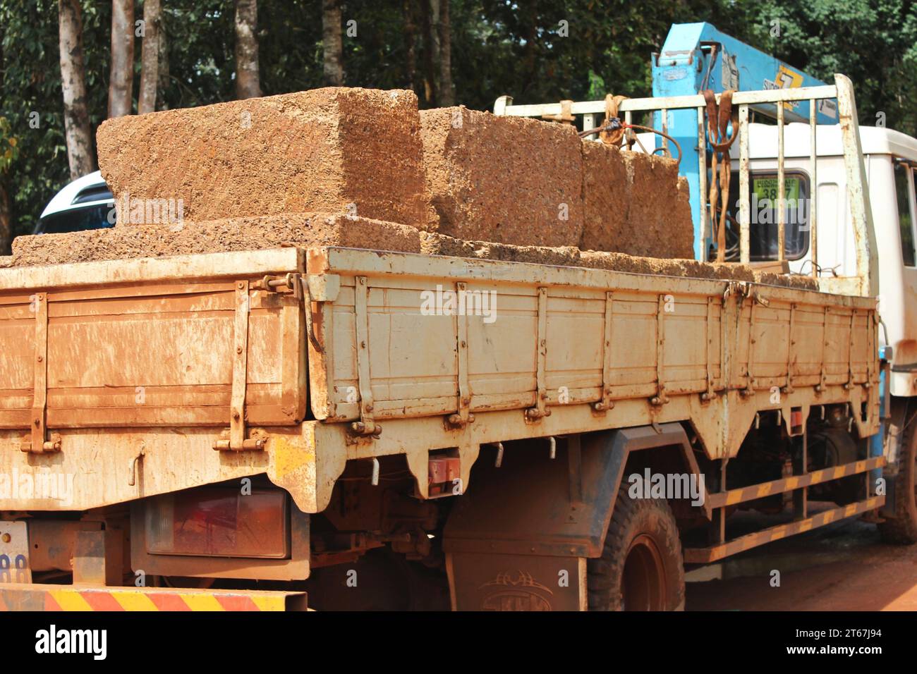 Truckload of large laterite building blocks to be used for repair and restoration projects at the Angkor Archaeological Park, near Siem Reap, Cambodia Stock Photo