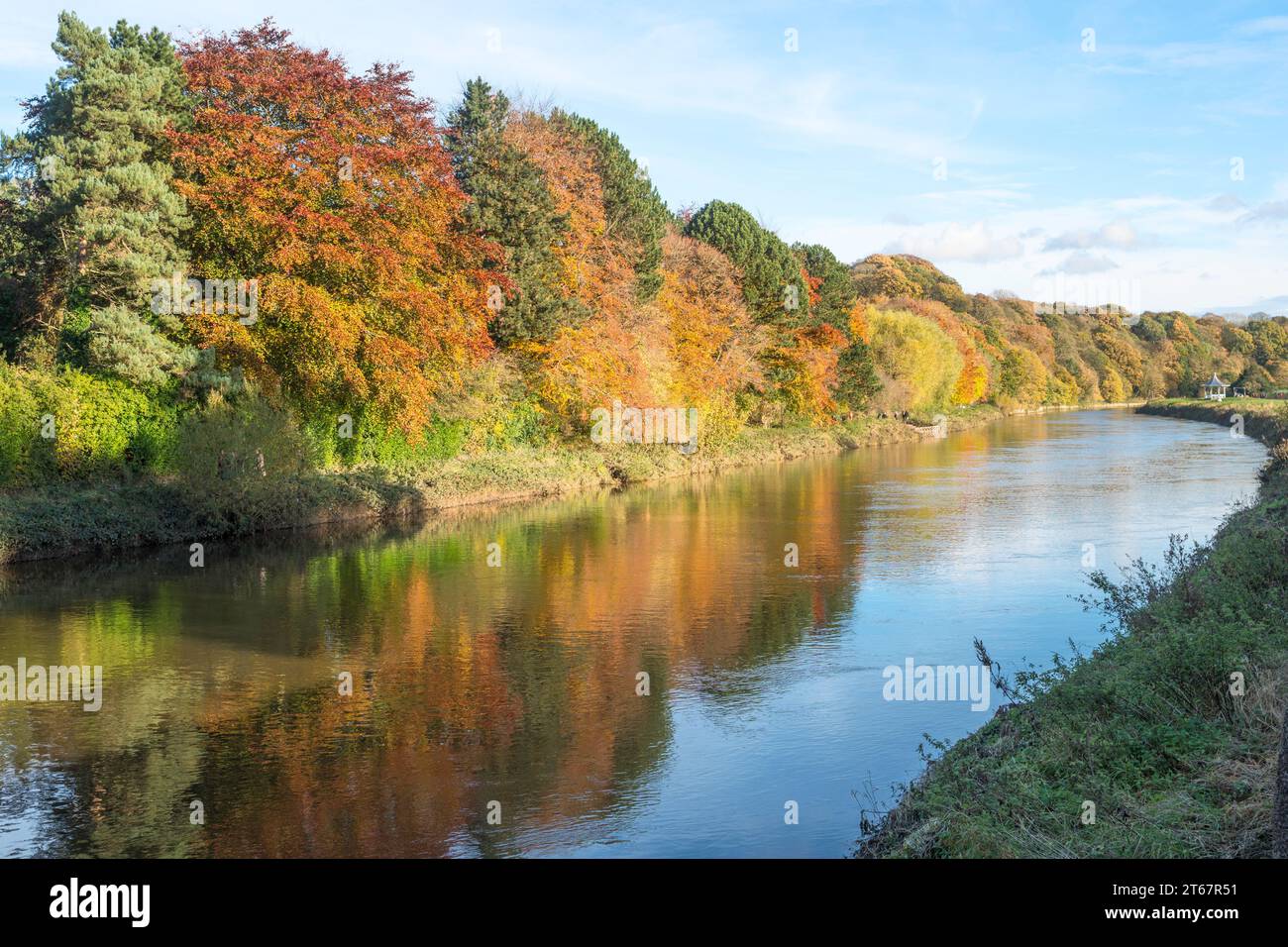 Autumn colours reflected in the river Wear in Durham city, England, UK Stock Photo
