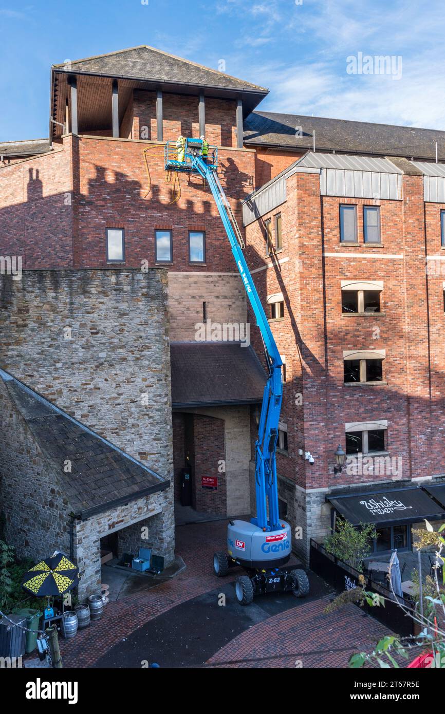 A Genie Z-62/40 Articulated Boom Lift or cherry picker at work in Durham City, England, UK Stock Photo