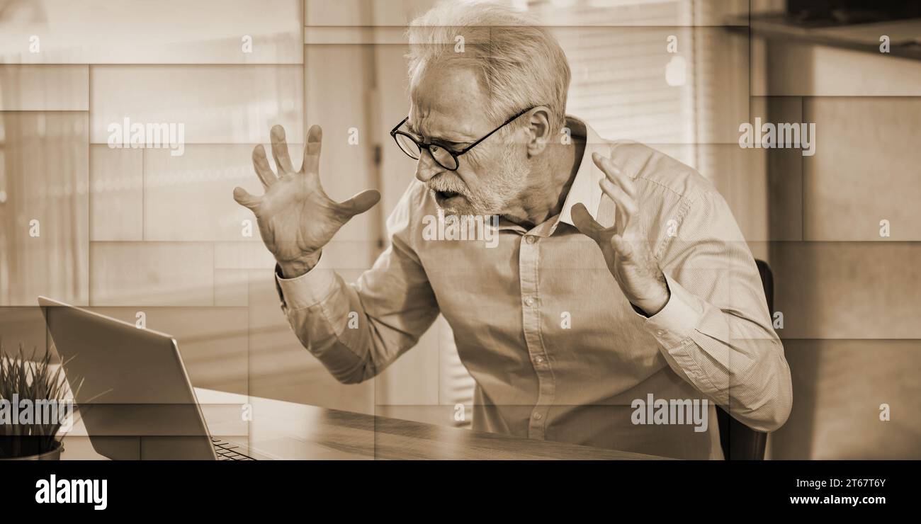 Enraged businessman in front of his laptop, geometric pattern Stock Photo