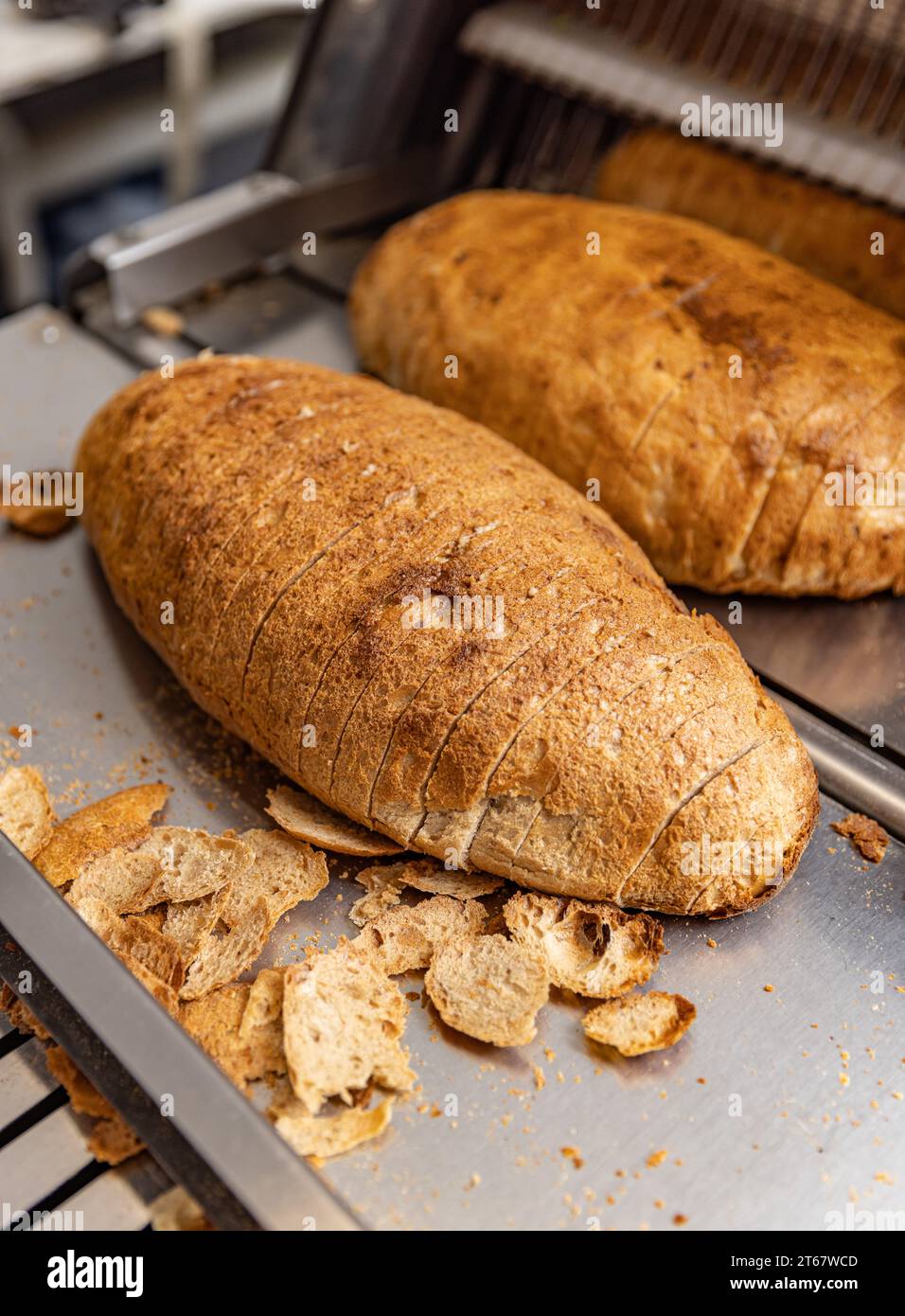 https://c8.alamy.com/comp/2T67WCD/bread-slicing-machine-sliced-bread-on-the-production-line-of-food-and-bakery-products-2T67WCD.jpg