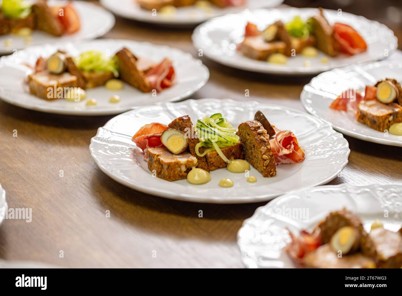 The starter plates are neatly arranged in rows on a restaurant kitchen