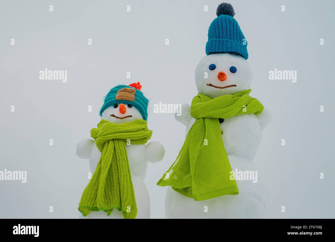 Snow man. Two snowman on snowy background Stock Photo - Alamy