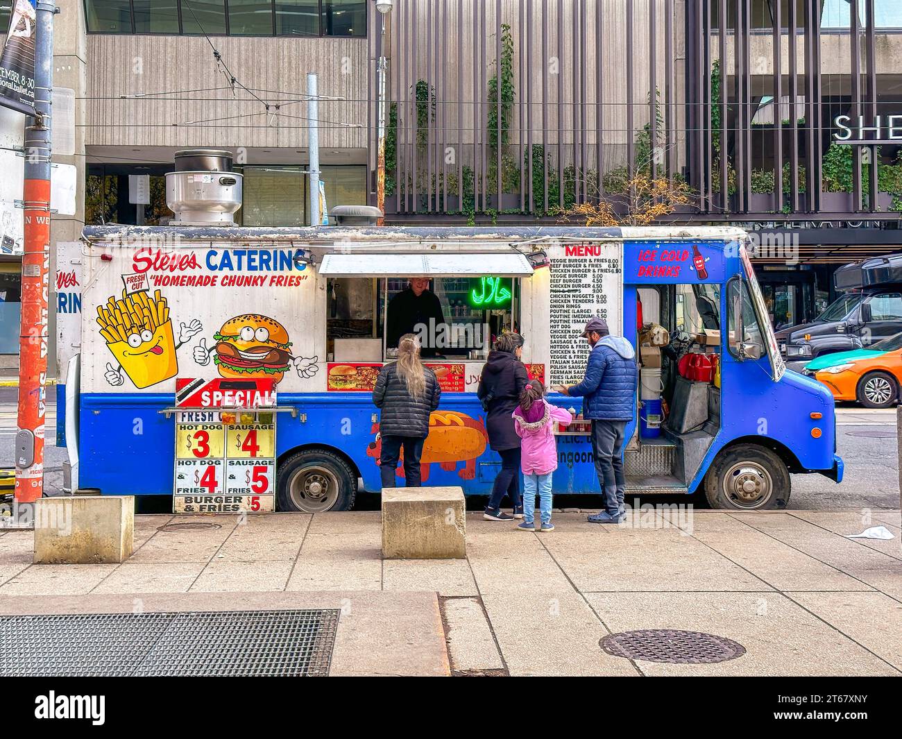 People buying street food from a truck in Nathan Phillips Square. Stock Photo
