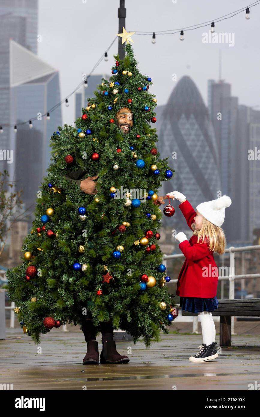 EDITORIAL USE ONLY Jemimah, aged 3, interacts with people dressed up as