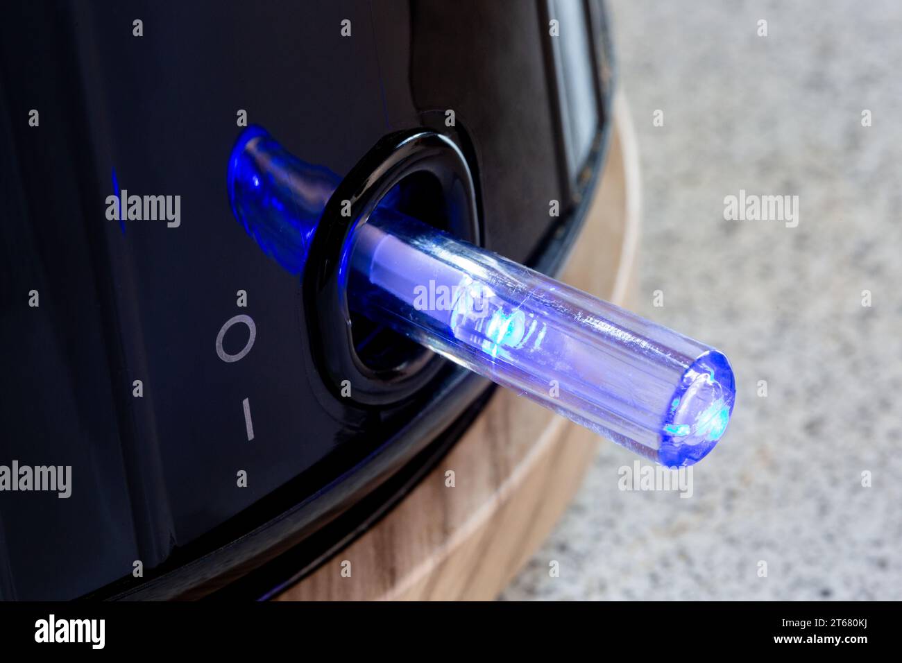 Electric Kettle power on button glowing blue Stock Photo