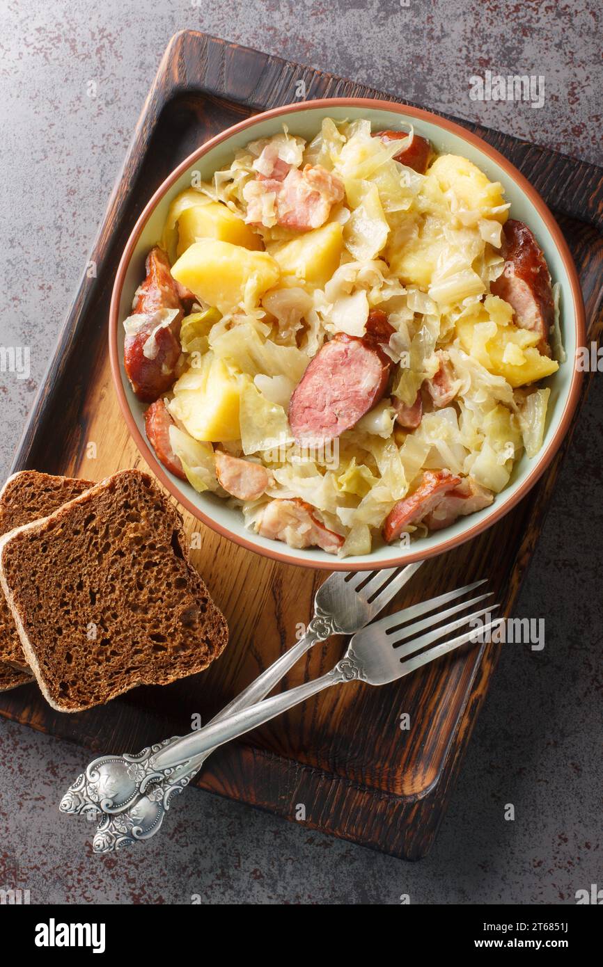 Jagerkohl German Hunter Cabbage Stew close-up in a bowl on the table. Vertical top view from above Stock Photo