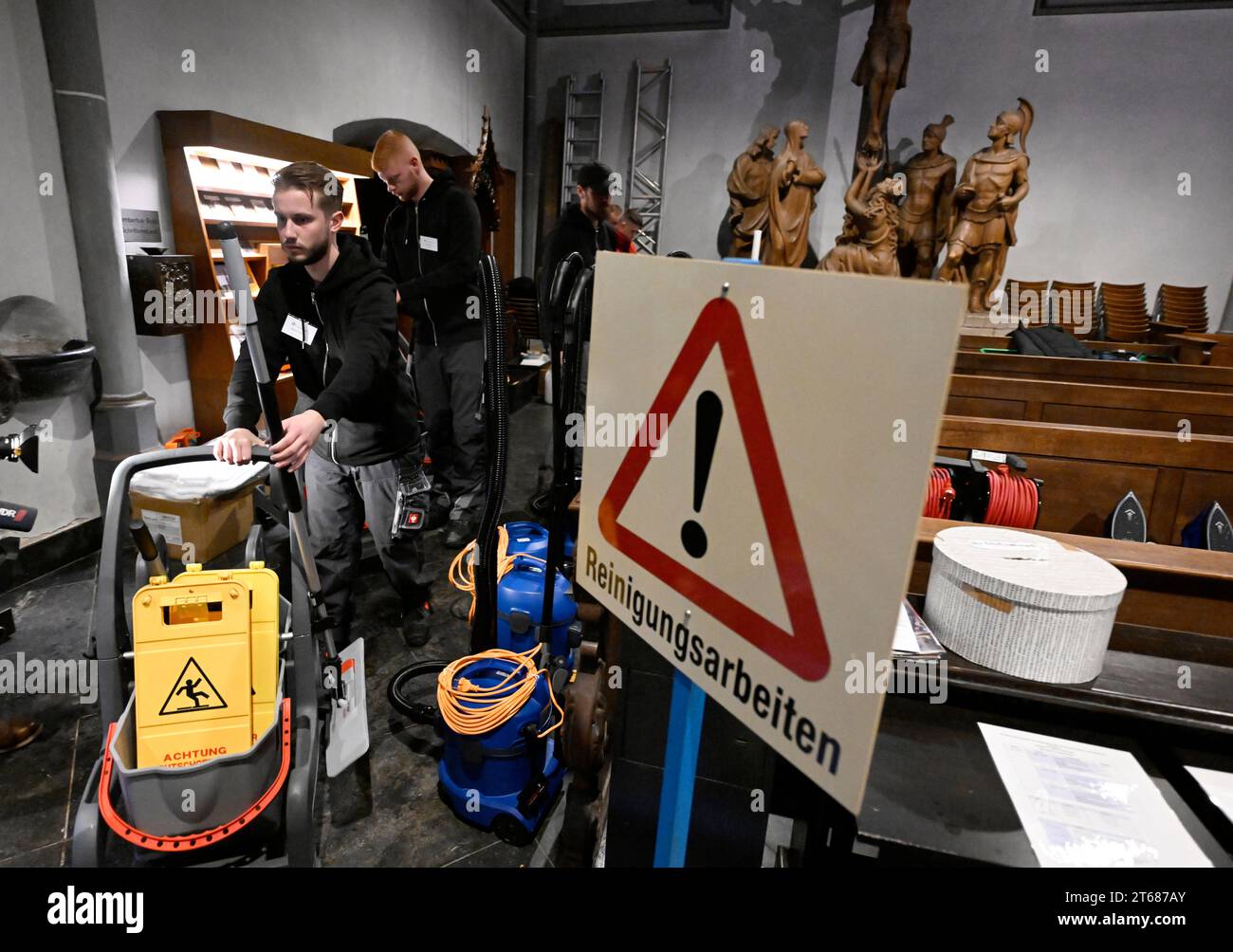 Duesseldorf, Germany. 09th Nov, 2023. Marvin Hübsch (l) from Krefeld and Leon Hunde (r) compete to clean the floor of St. Lambert's Basilica at the German Building Cleaning Championships. Credit: Roberto Pfeil/dpa/Alamy Live News Stock Photo