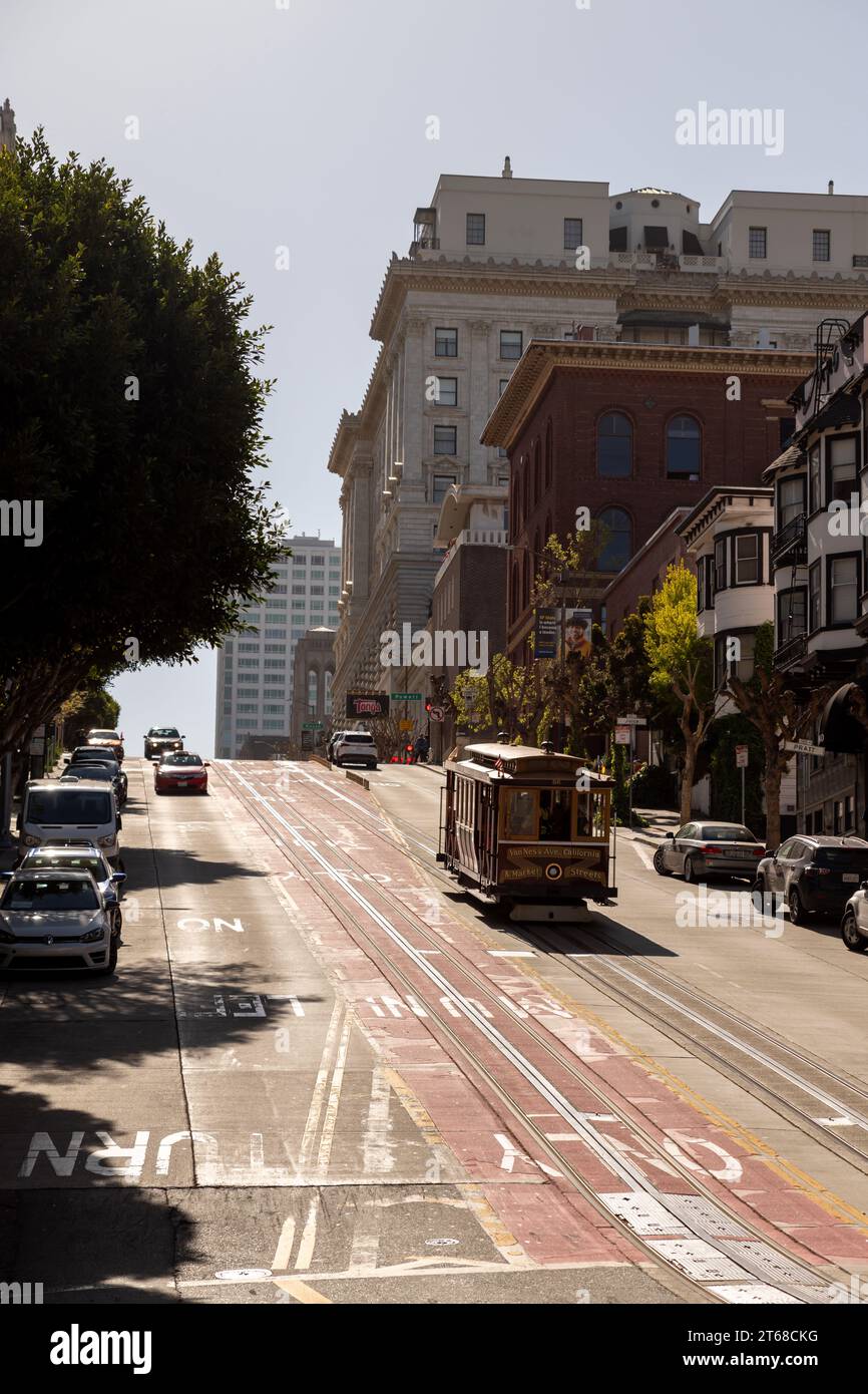 San Francisco, California - April 26, 2023: Surface level of road markings on diminishing tramway leading towards modern buildings Stock Photo
