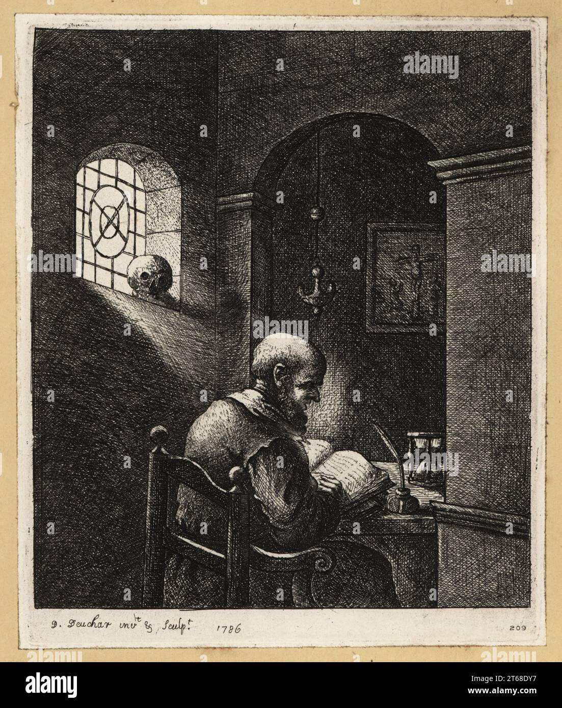 17th century monk reading a Bible at a desk in his cell. A quill pen ...