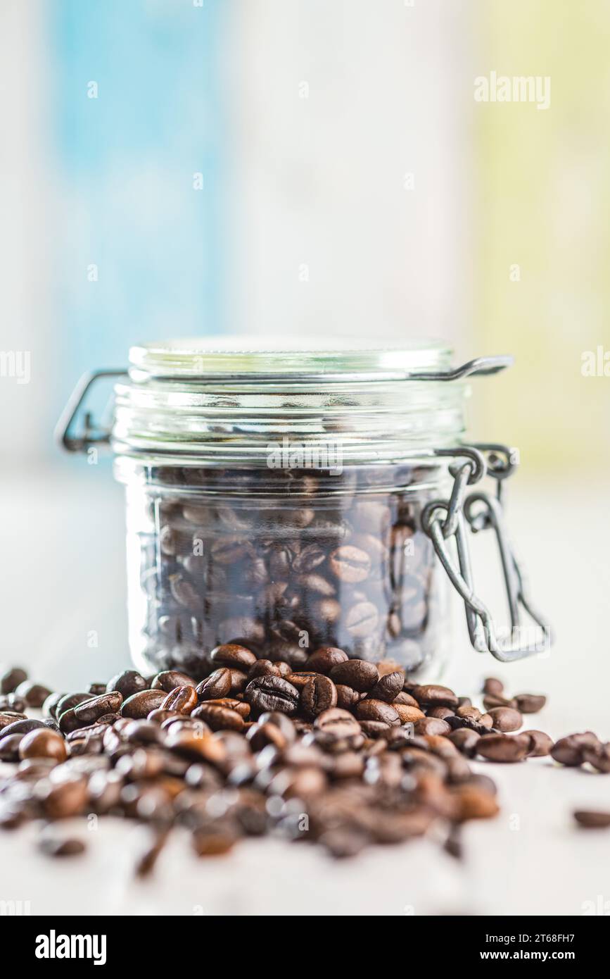 Roasted coffee beans on the white kitchen table. Stock Photo
