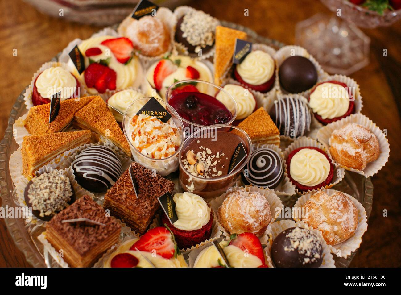An ornately decorated platter filled with an array of delectable pastries, desserts and candies. Stock Photo