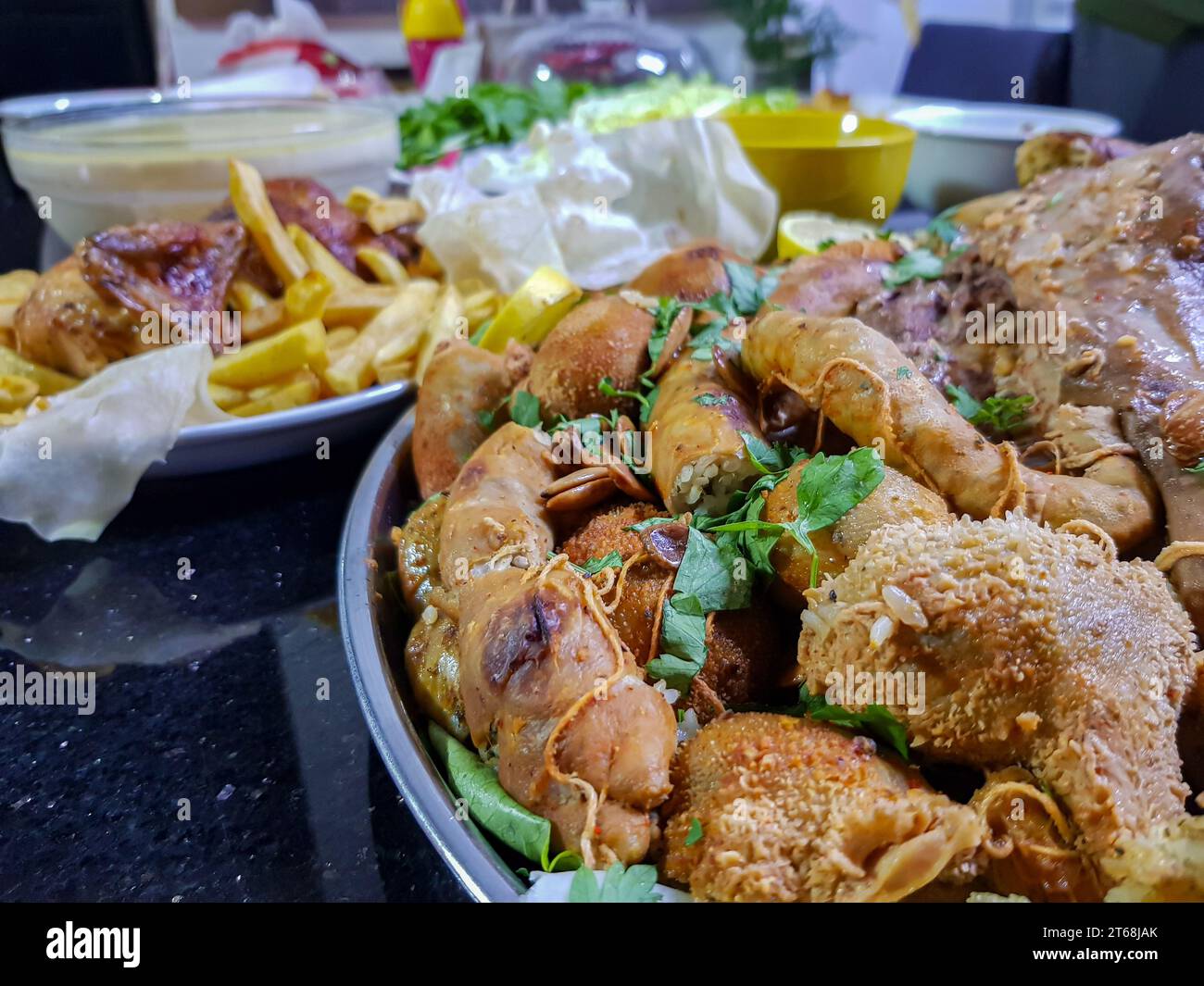 Top view of Tripes, empties, and legs with lemon and herbs on black background on table ready to be eaten Stock Photo