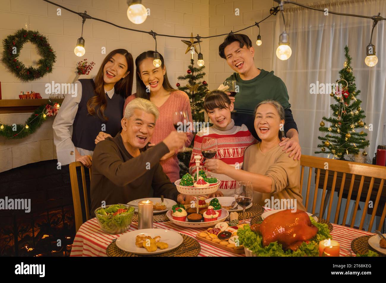 Celebrating Thanksgiving and Christmas with an Asian family  cherishing every moment with a spread of delectable food Stock Photo