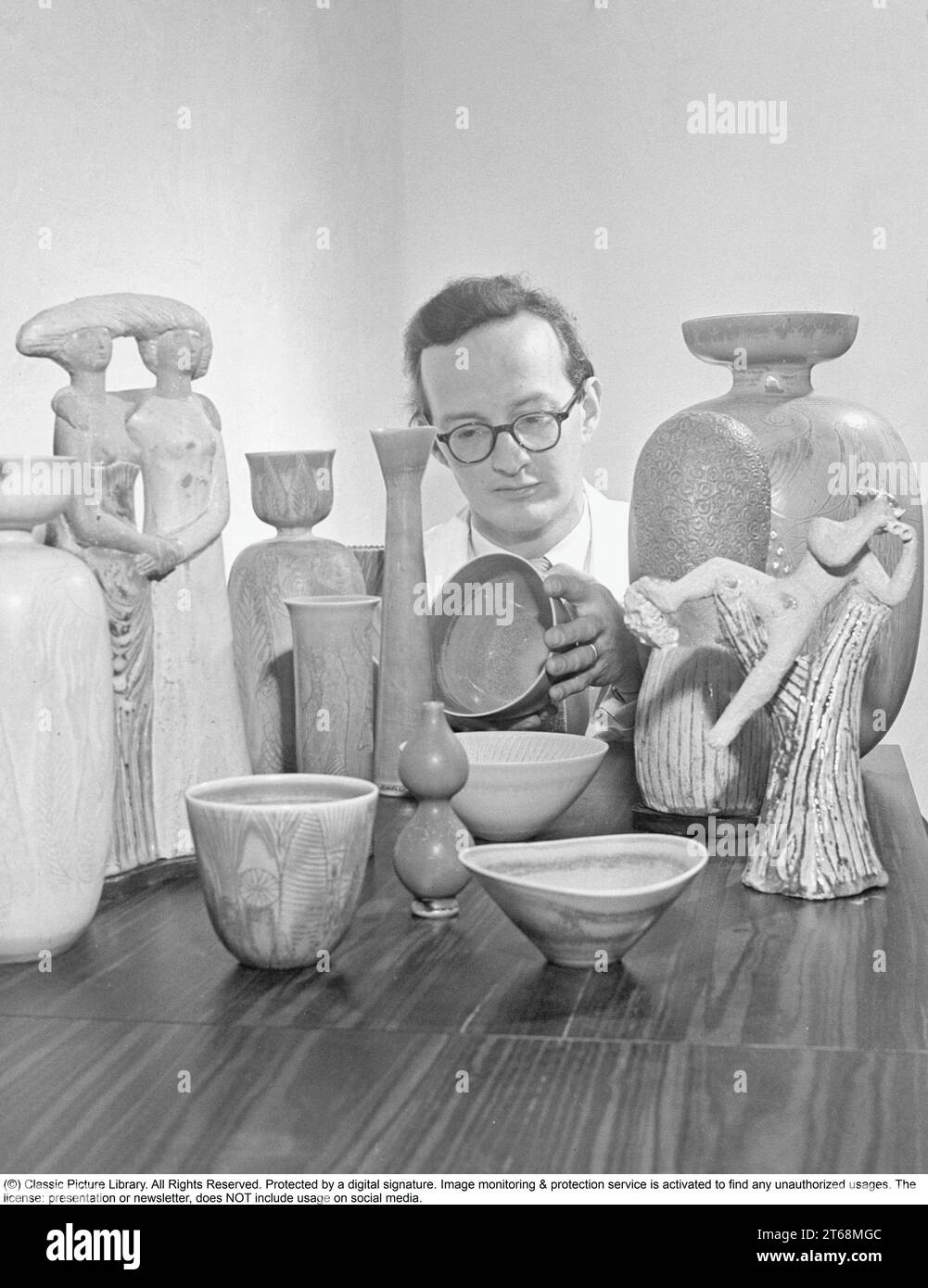 Stig Lindberg (17 August 1916 in Umeå, Sweden – 7 April 1982 in San Felice Circeo, Italy) was a Swedish ceramic designer, glass designer, textile designer, industrial designer, painter, and illustrator.   One of Sweden's most important postwar designers, Lindberg created whimsical studio ceramics and graceful tableware lines during a long career with the Gustavsberg pottery factory. Stig Lindberg studied painting at the University College of Arts, Crafts and Design. In 1937, he went to work at Gustavsberg under Wilhelm Kåge. In 1949, he was named Kåge's successor as art director. From this per Stock Photo