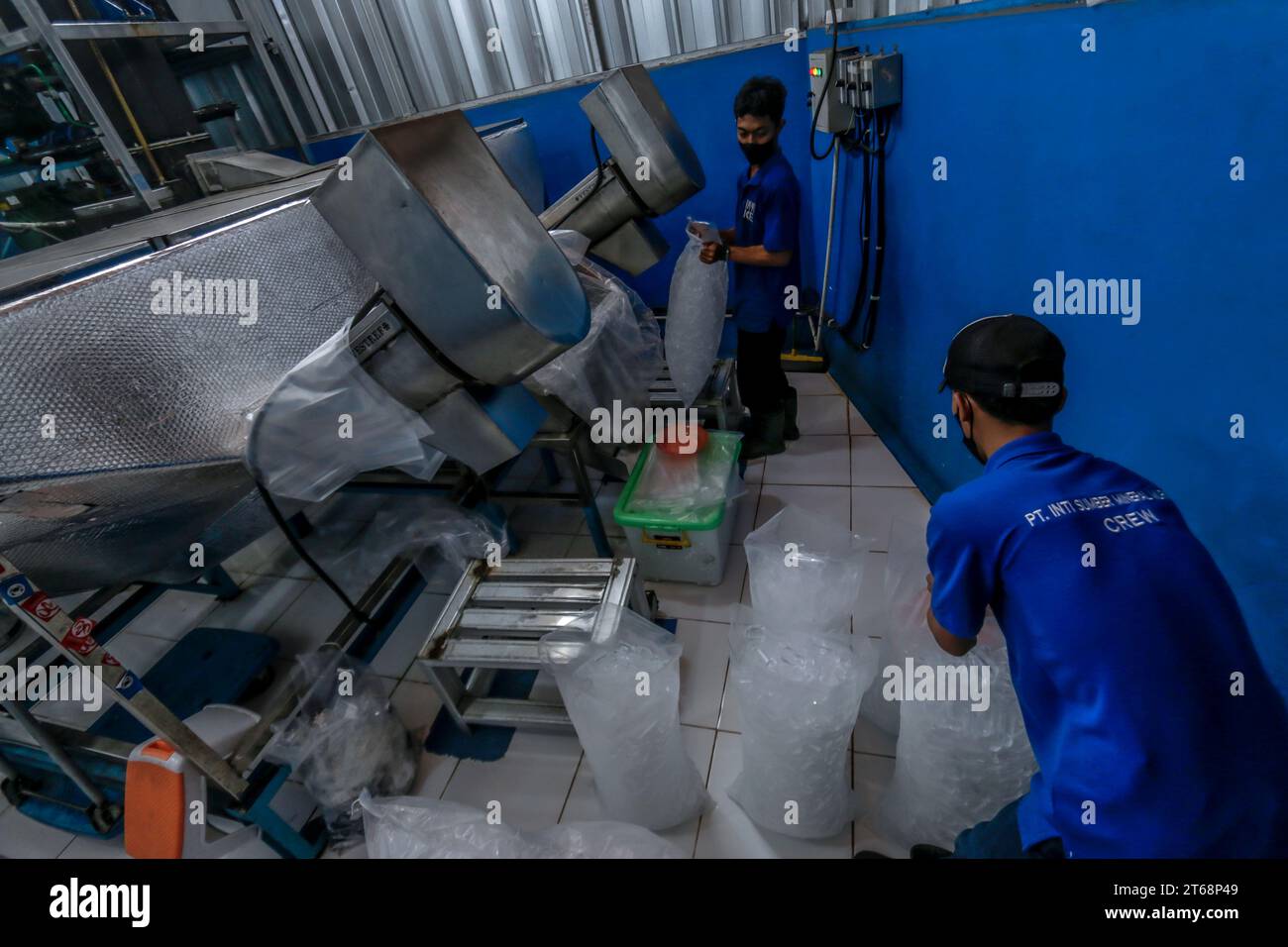 Workers pack crystal ice cubes at a crystal ice cube factory in Bogor, West Java, Indonesia, on