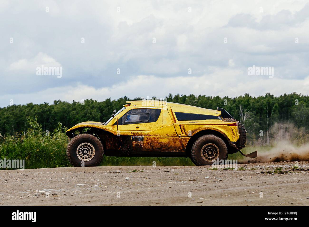side view racing car moving on terrain road in cross country rally Stock Photo