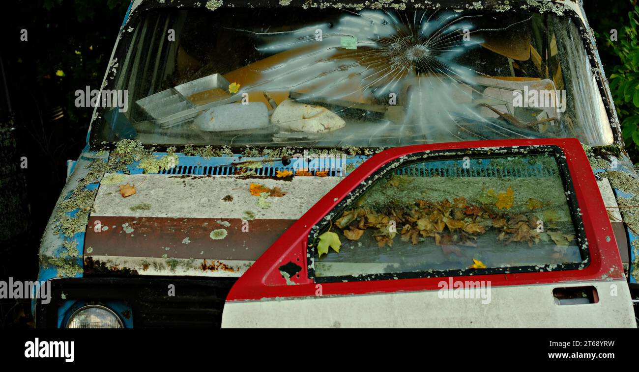 An old van with a broken windshield in a junkyard Stock Photo Alamy