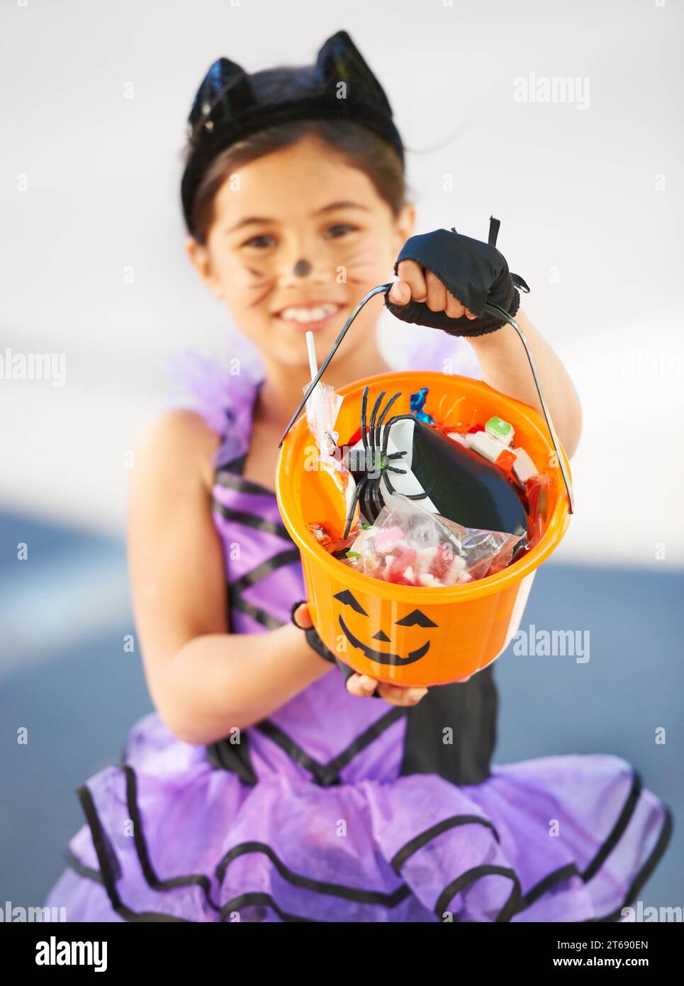 Want some Halloween candy. Little girl dressed in a Halloween costume