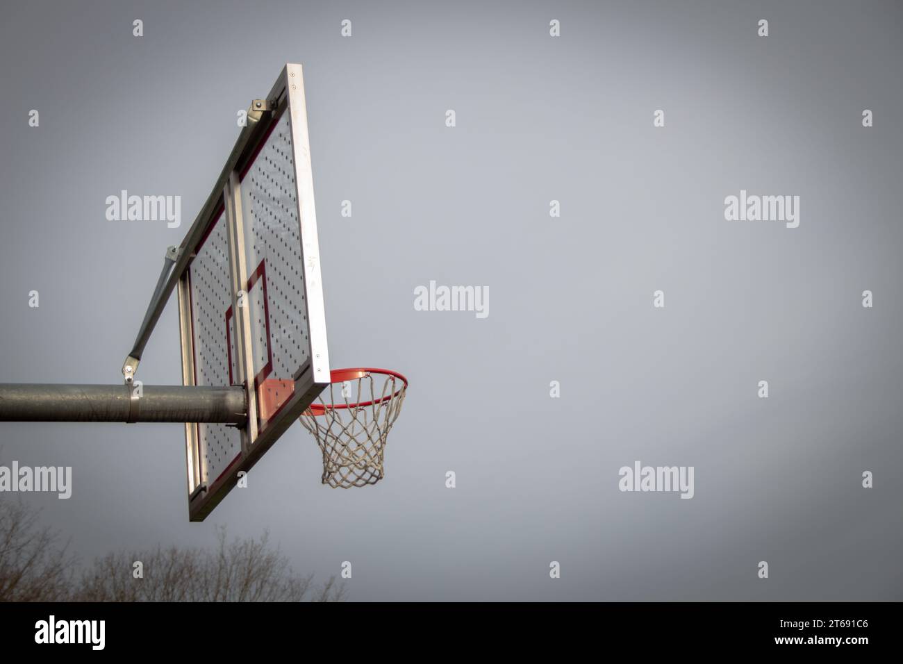 Basketball hoop with a grey sky. Stock Photo