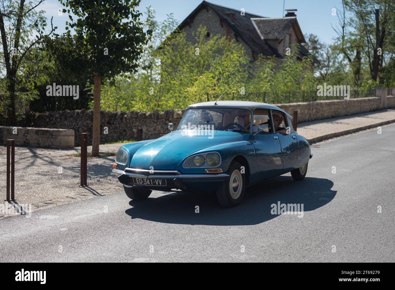 A beautiful classic blue Citroen DS with a white roof driving through a French town Stock Photo