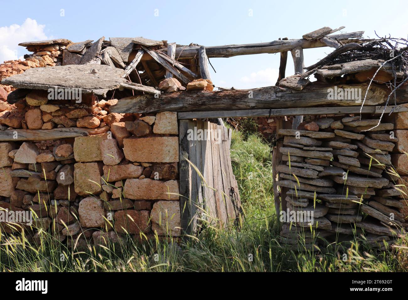 Very old abandoned stone garden house. Stock Photo