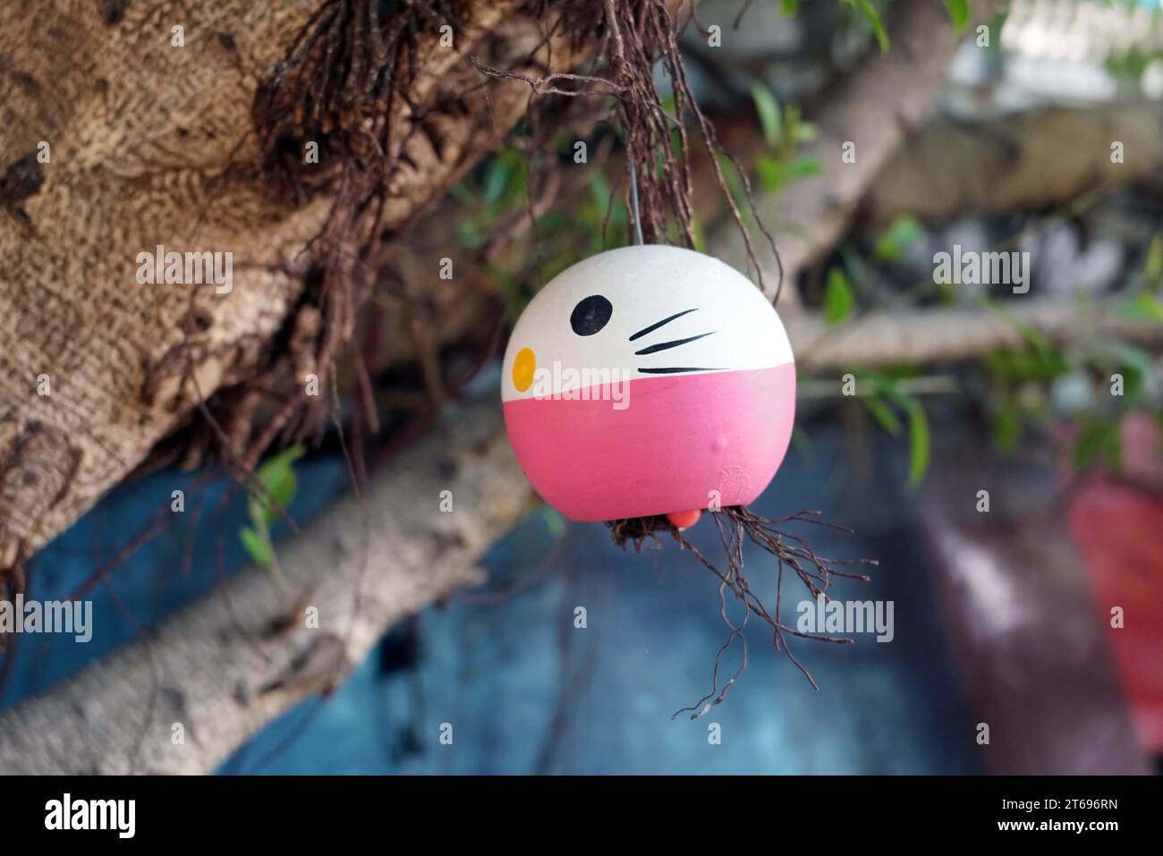Funny white ping egg with face hang on in garden Stock Photo - Alamy