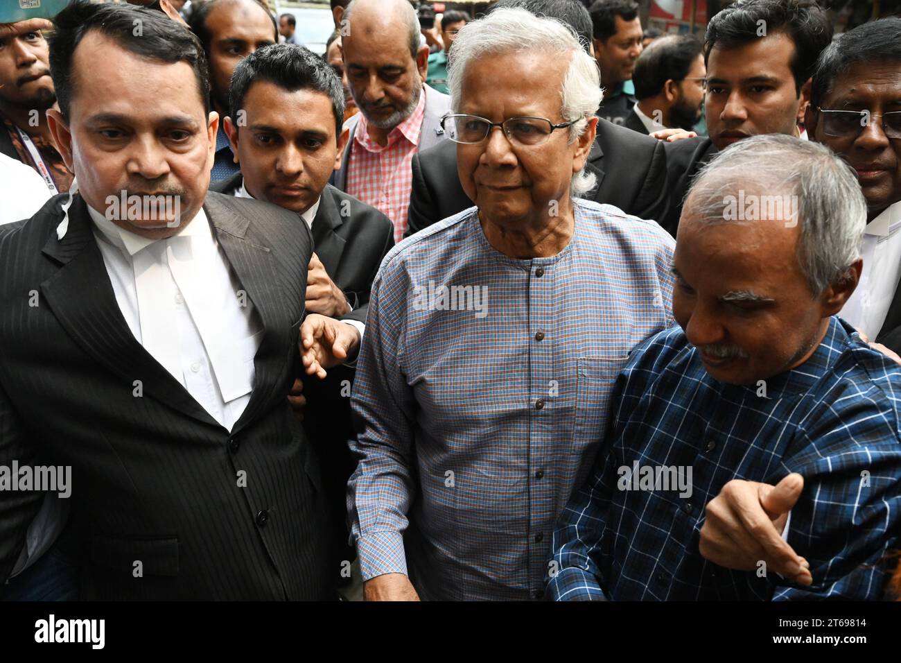 Nobel laureate Muhammad Yunus (C) arrives with his lawyers for a ...
