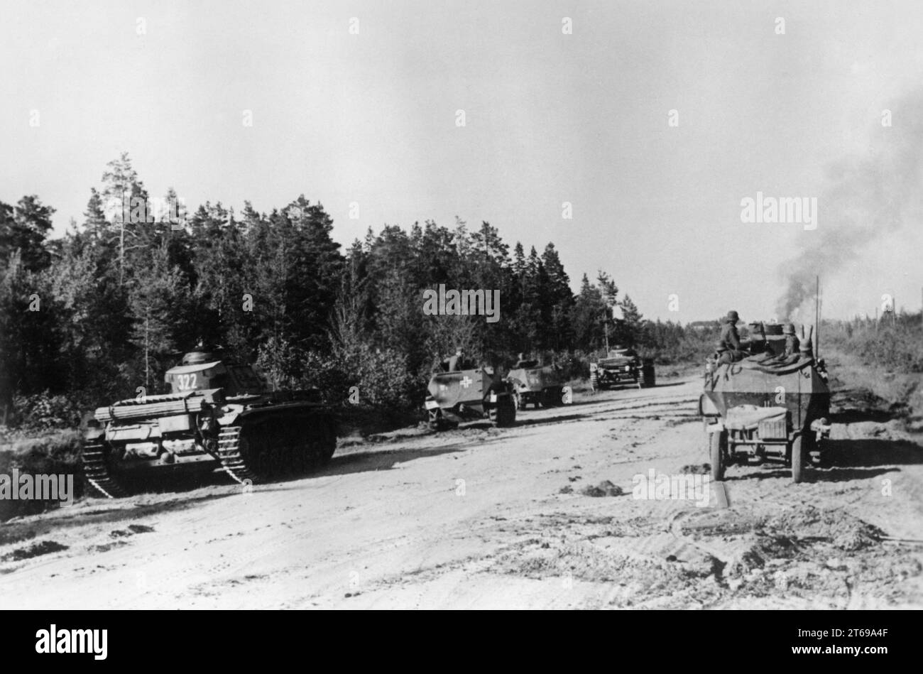 German Panzer III (left and center) and infantry fighting vehicle Sd.Kfz. 251 on the advance road towards Pskow / Pleskau. Photo: Schürer. [automated translation] Stock Photo
