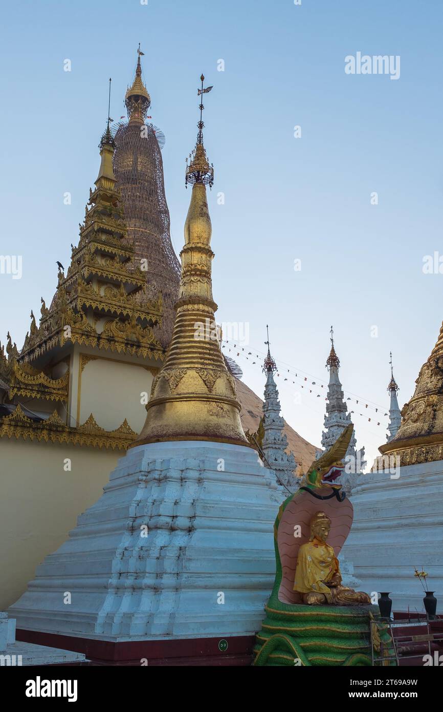 Yangon, Myanmar. At the Shwedagon Pagoda, a statue of Gautama Buddha after he achieved enlightenment sheltered from the elements by Muchalinda (naga) Stock Photo