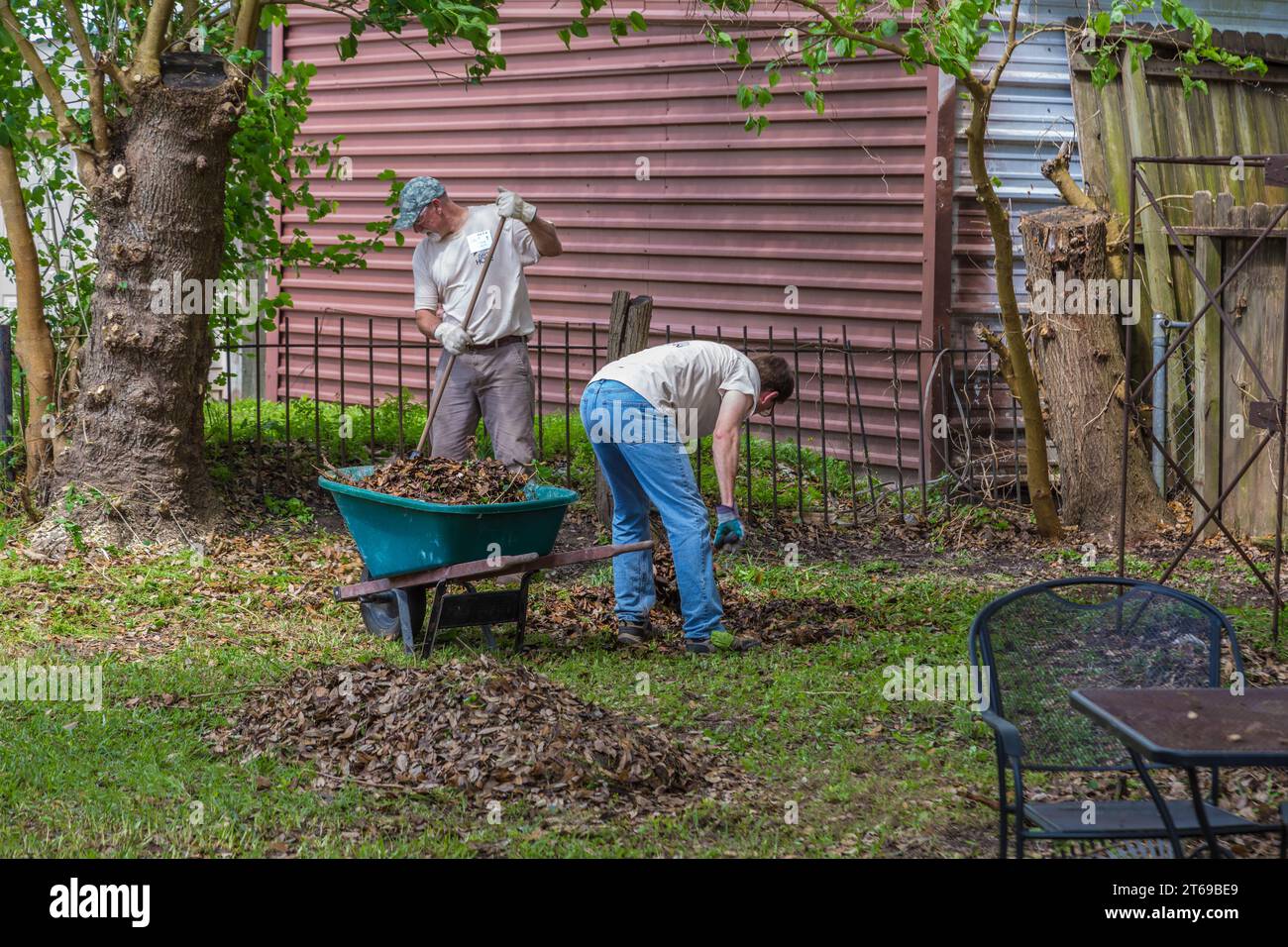 Members of 8 Days of Hope faith based charity volunteer team cleaning up the yard of a home that was flooded in Houston, Texas Stock Photo