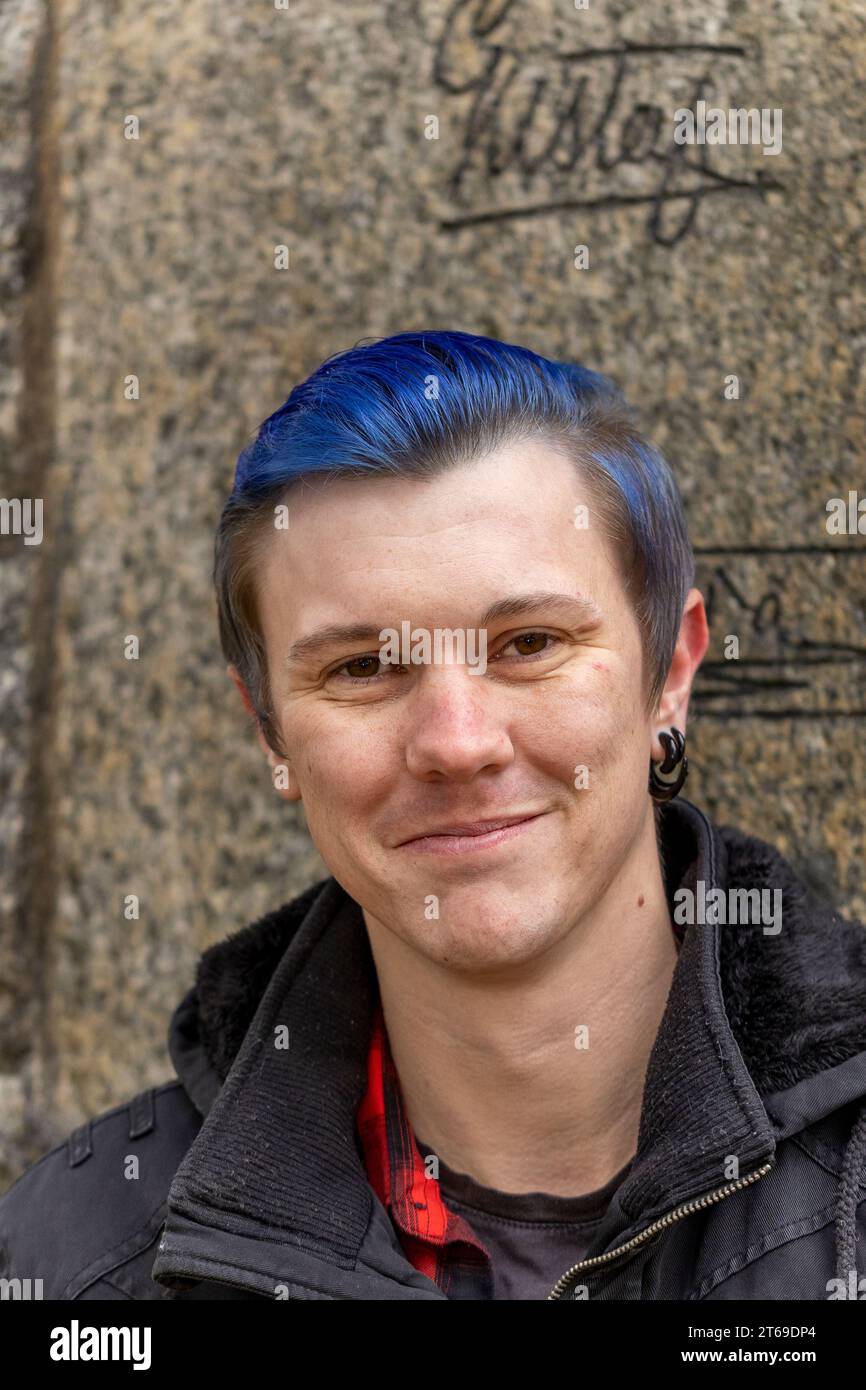 Young man in close-up and with blue color in the hair Stock Photo - Alamy