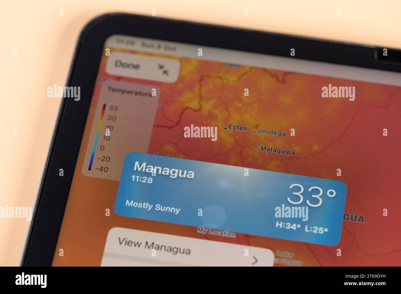New York, USA - October 8, 2023: Checking temperature outside in Managua city on online app ipad tablet screen close up view Stock Photo