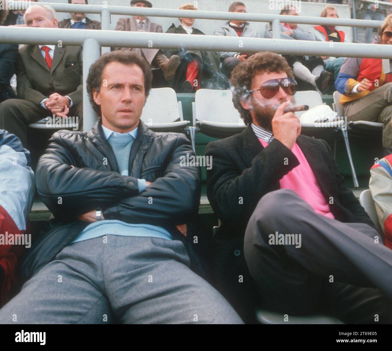 Franz Beckenbauer (left) and Paul Breitner as spectators at the match between FC Bayern München and 1. FC Köln on 22.09.1984. Breitner smoking a cigar [automated translation] Stock Photo