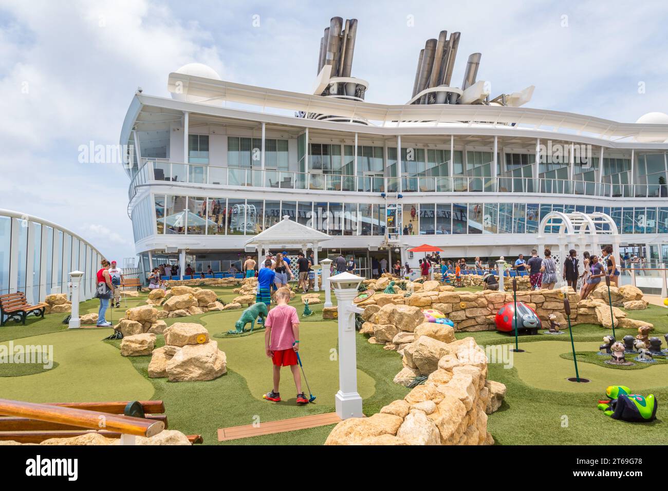 Cruise passengers playing miniature golf on the Royal Caribbean Allure of the Seas cruise ship Stock Photo