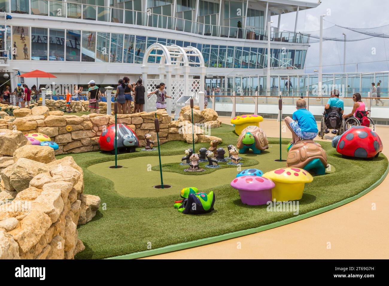 Cruise passengers playing miniature golf on the Royal Caribbean Allure of the Seas cruise ship Stock Photo