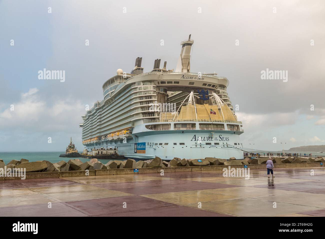 Royal Caribbean Allure of the Seas being refueled from a fuel barge on a rainy morning at the port of Phillipsburg, St. Maarten in the Caribbean Stock Photo