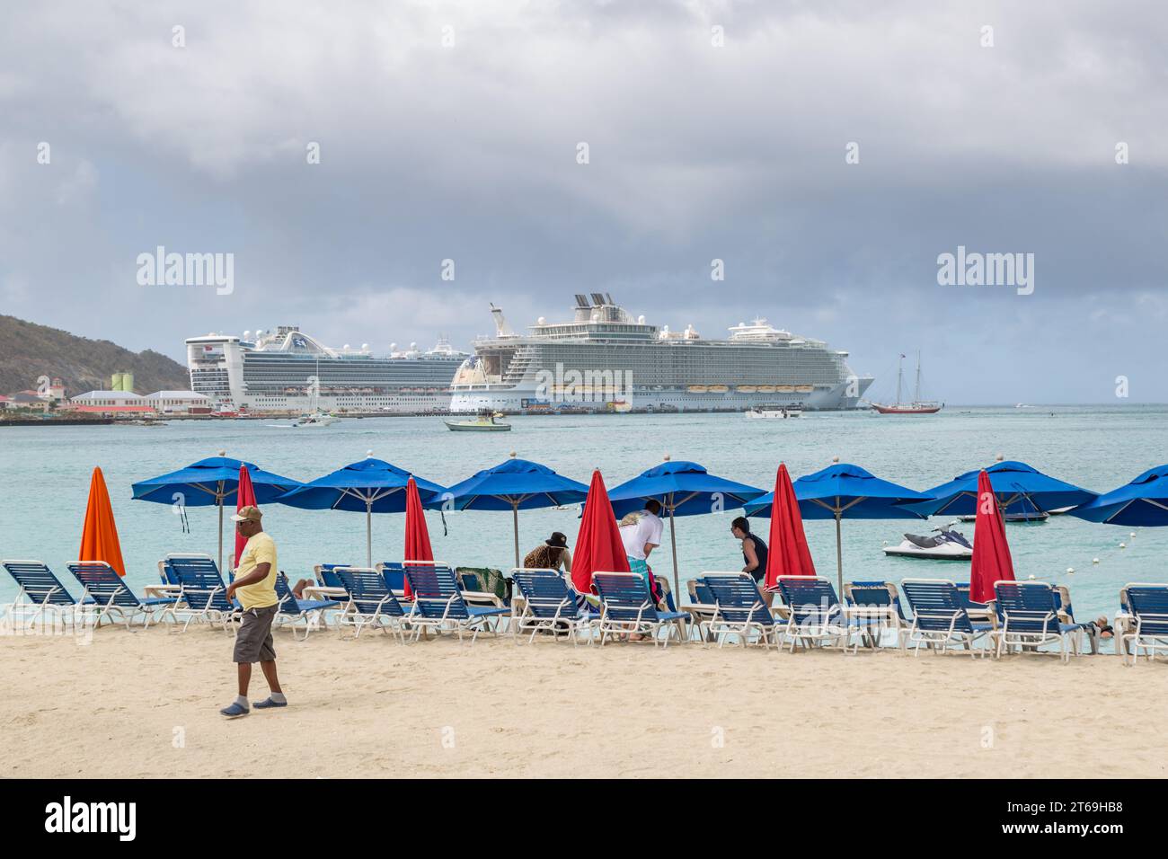 Tourists setting up on the beach on a rainy morning at the port of Phillipsburg, St. Maarten in the Caribbean Stock Photo