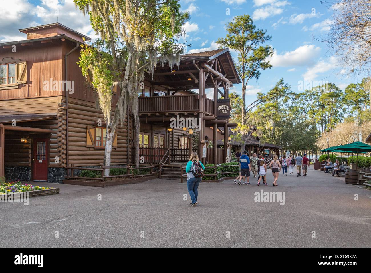 Visitors walking through Fort Wilderness Campground near Pioneer Hall