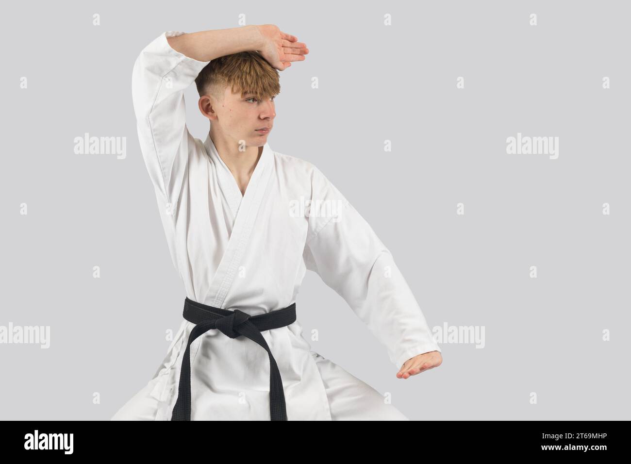 Black belt teenage boy performing a kata Stock Photo