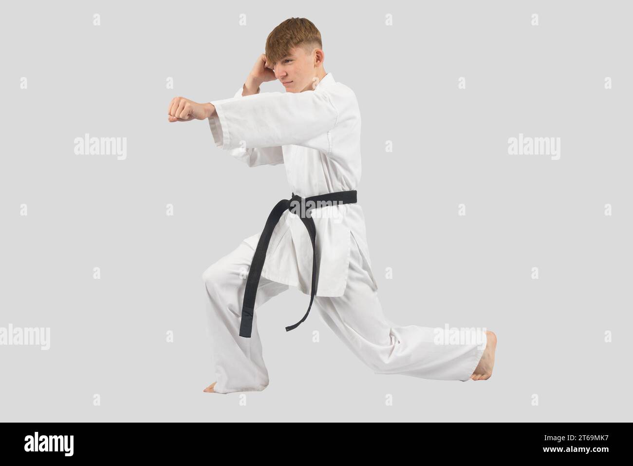 Black belt teenage boy performing kata Stock Photo