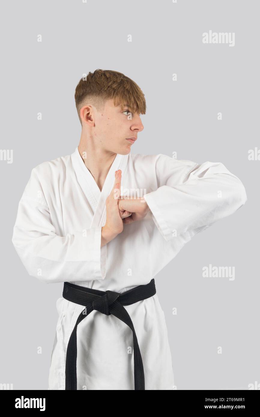 Black belt teenage boy performing a kata Stock Photo