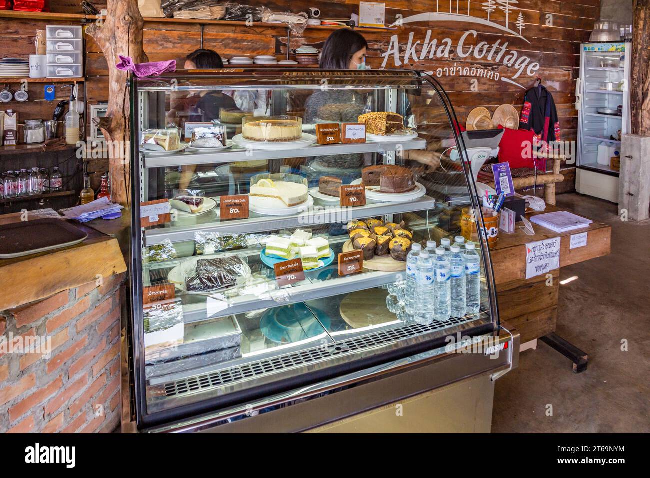 Fresh desserts on display in refrigerated case at the Akha Cottage restaurant and coffee shop in Chiang Rai, Thailand Stock Photo