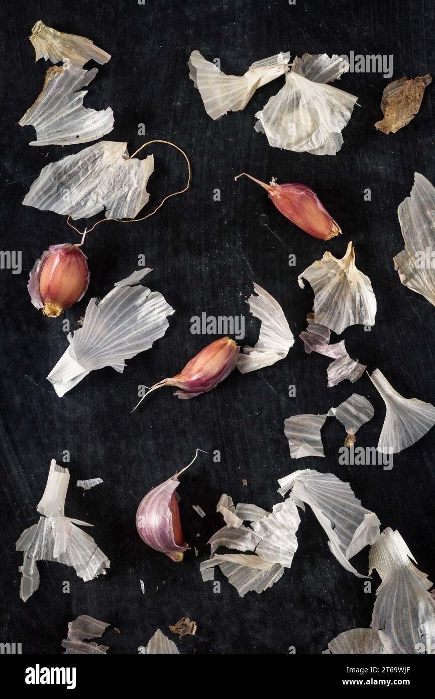 Fresh garlic bulbs and cloves grouped on black background. Flat lay ...