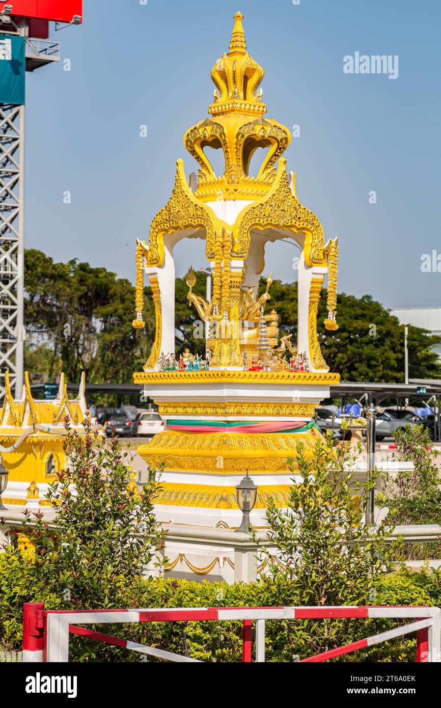 Buddahist shrine outside of the Mega Home building materials warehouse store in Chiang Rai province of Northern Thailand Stock Photo