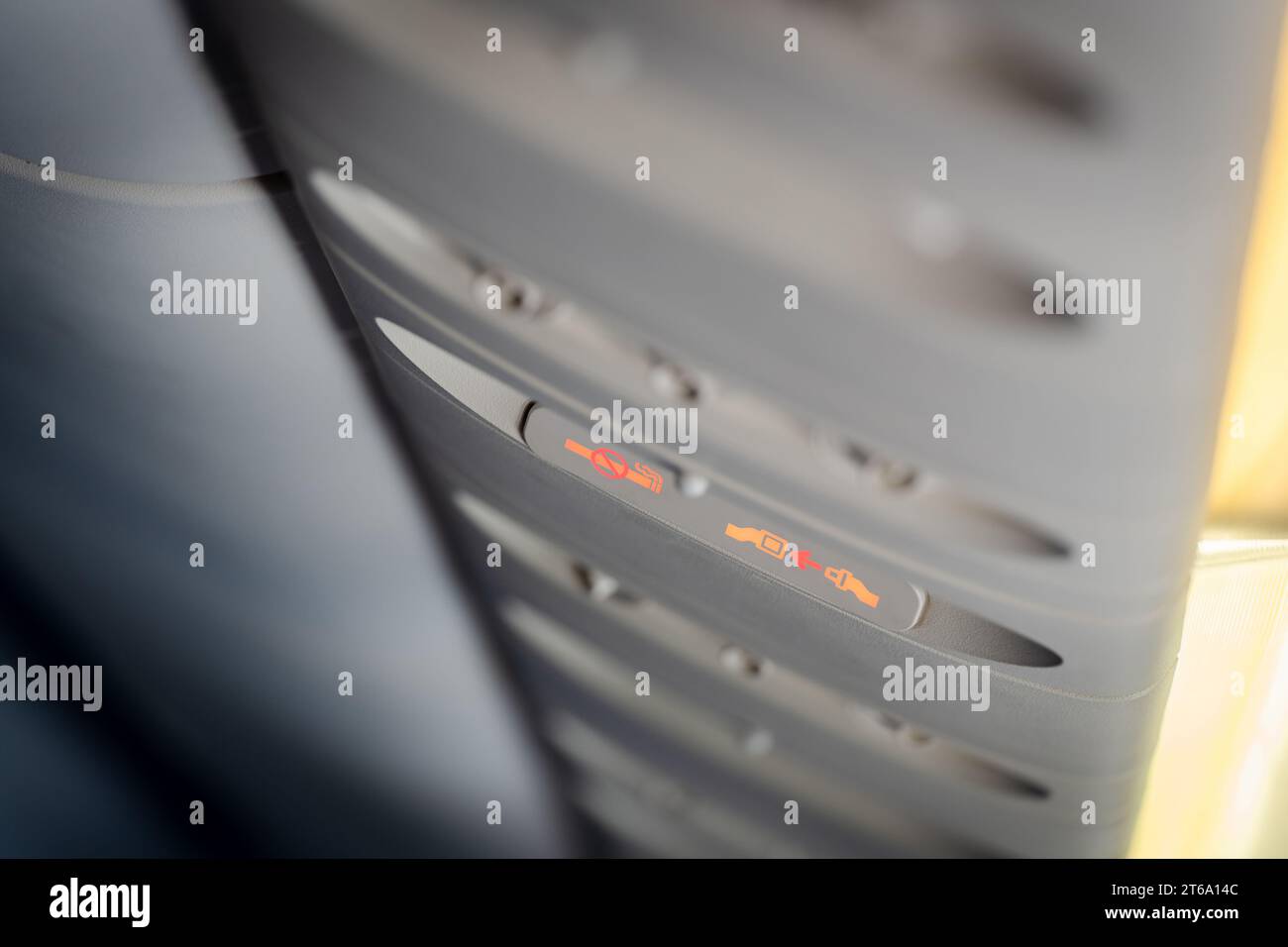 Fasten seat belt and no smoking signs in aircraft, overhead console of