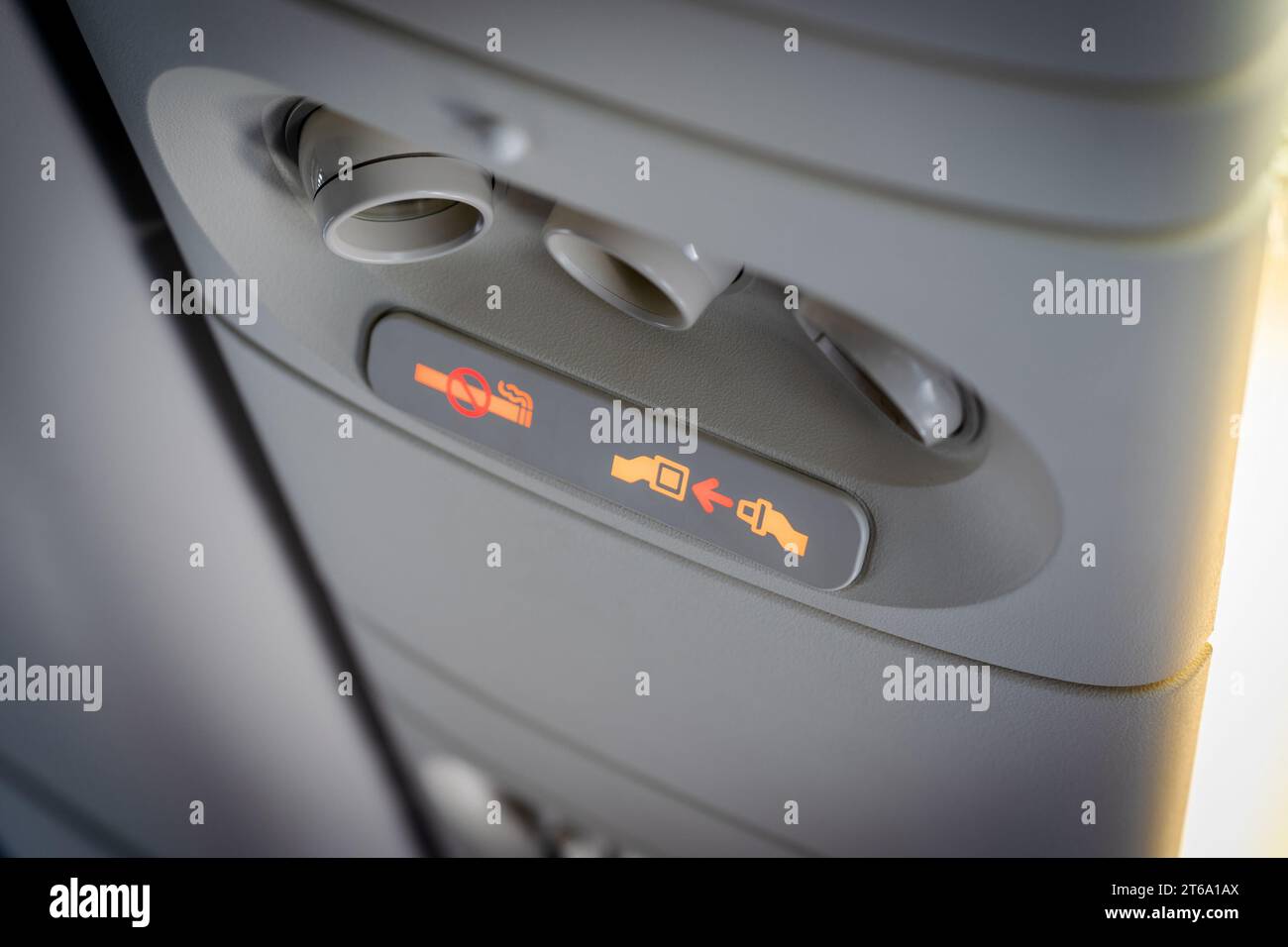 Fasten seat belt and no smoking signs in aircraft, overhead console of