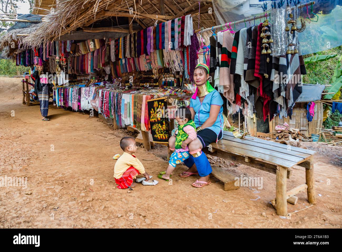 Tribal woman with two children in the Long Neck Karen tribe (Kayah ...